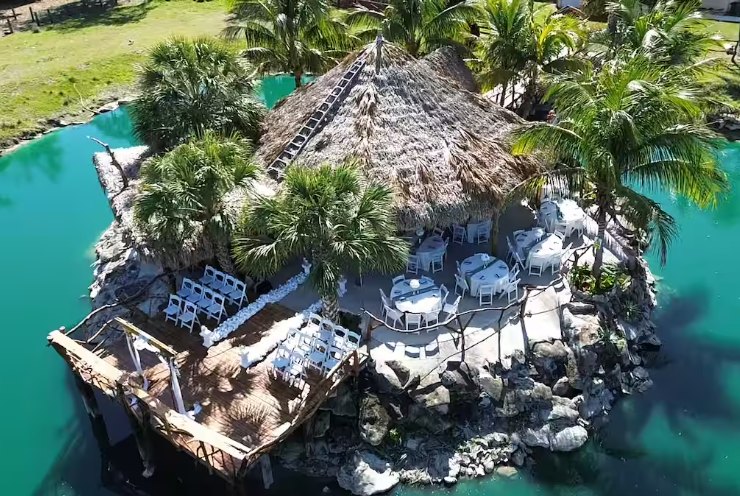 Aerial view of the covered pavilion on a private island surrounded by a turquoise spring-fed lagoon in Okeechobee, Florida